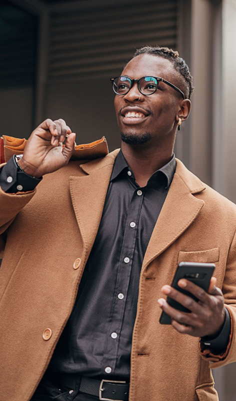 Man sending money on smartphone outdoors